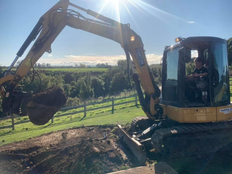 Digger preparing ground for concrete slab